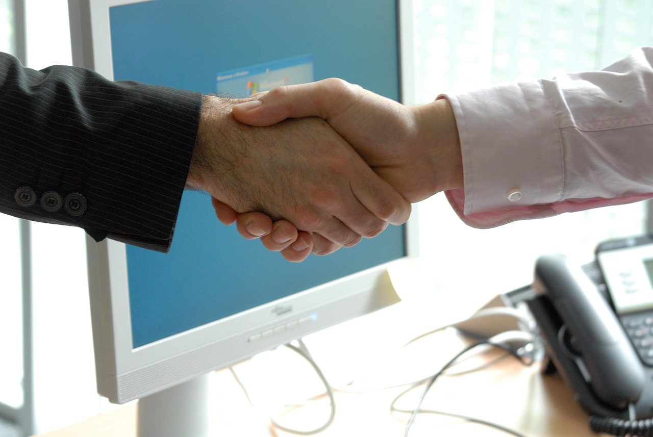 Hand shake, business, professional — Discover the Ease of Managing Crypto with Ledger Live